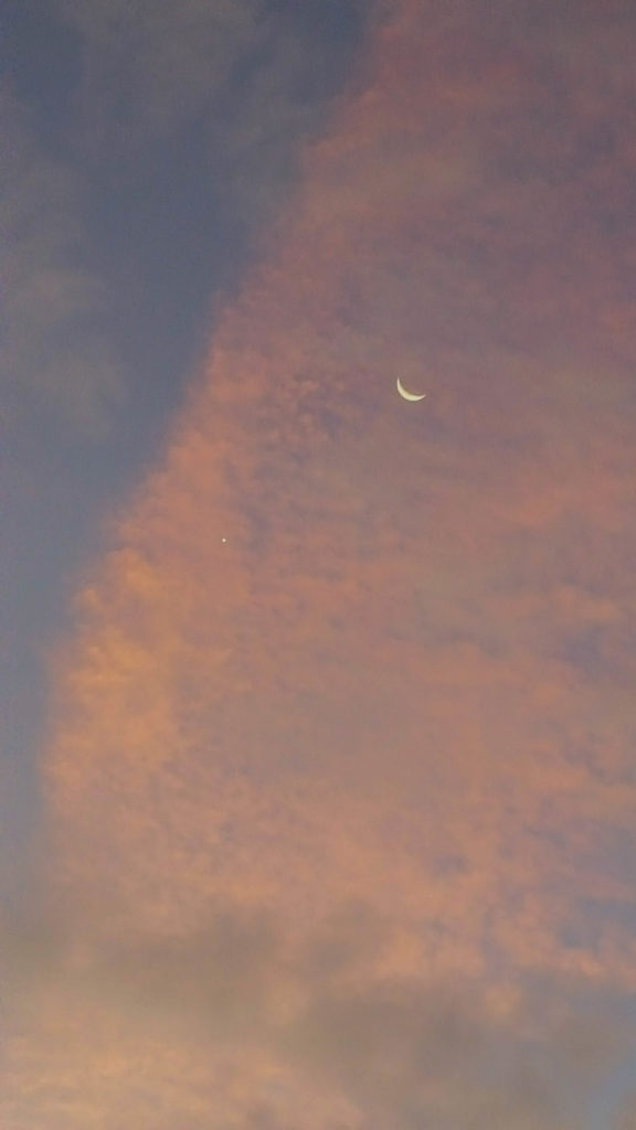 Moon and Venus behind airplane contrail